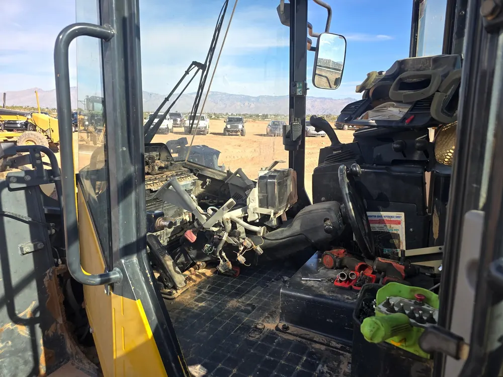 Heavy equipment cab with panels open for electrical diagnostics
